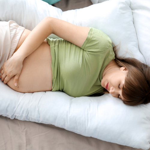 First time pregnant mom lying on pillow