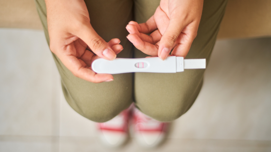 a person holding a pregnancy test